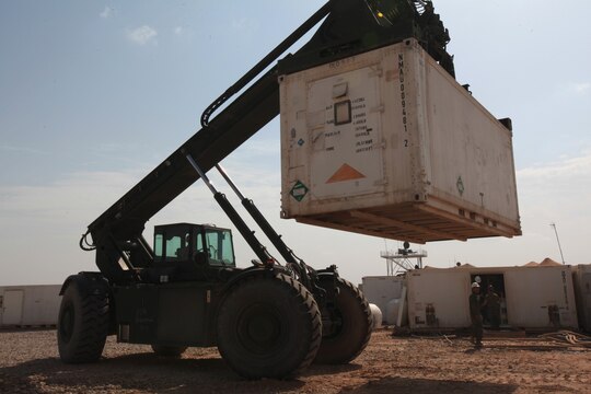 A Marine with Marine Wing Support Squadron 273 hauls a mobile maintenance facility across the Marine Aviation Logistics Squadron 16 compound aboard Camp Bastion, Afghanistan, April 19, 2012. MALS-16 will send almost 150,000 pounds of maintenance equipment back to the United States over the next two days as part of the Marine Corps' downsizing efforts in Afghanistan.