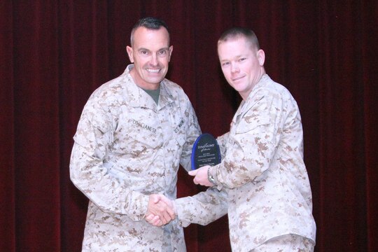 Steve (right) and Judy Wagner (left), 2nd Battalion, 5th Marines Family Readiness Program assistants and advisors, accept an award from Brig. Gen. Vincent Coglianese (center), commanding general of Marine Corps Installations West, for Team Volunteer of the Year during a recognition ceremony at the Pacific Views Event Center at Camp Pendleton, Calif., April 19.  The Wagner team served more than 1000 hours volunteering for holiday parties, baby showers, pre-deployment briefs, cleaning barracks rooms and improving the quality of life of Marines, sailors and family members of the unit. Their off-base service included Operation Help a Hero.