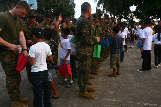 Filipino children from the Bahay Ni Nanay Orphanage receive bags of school supplies donated from U.S. Marines and sailors at Antonio Bautista Air Base in Puerto Princesa, Palawan, Republic of the Philippines, April 21, 2012. The children and service members spent several hours together getting to know one another and playing games. The service members are currently here for the duration of Balikatan 2012 and are a part of Task Force Palawan. BK12 is a bilateral, joint exercise conducted annually between the U.S. and the Republic of the Philippines. This year marks the 28th iteration of the nations' exercise.