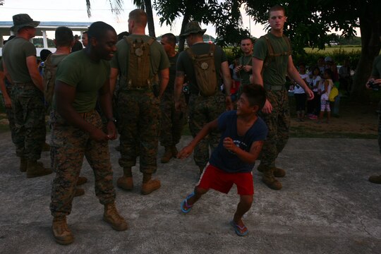 A Filipino child from the Bahay Ni Nanay Orphanage jokes with a U.S. Marine at Antonio Bautista Air Base in Puerto Princesa, Palawan, Republic of the Philippines, April 21, 2012. The children of the orphanage, Marines and sailors spent several hours together getting to know one another. The service members are currently here for the duration of Balikatan 2012 and are a part of Task Force Palawan. BK12 is a bilateral, joint exercise conducted annually between the U.S. and the Republic of the Philippines. This year marks the 28th iteration of the nations' exercise.