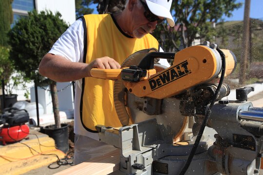A certified carpenter cuts a new frame for the Camp Pendleton's School of Infantry West's Caruso Memorial Chapel's main entrance, April 28. Sixty volunteers from the Church of Latter Day Saints helped spruce up the more than 50 year-old chapel, which received landscaping upgrades, interior renovation and new windows. The chapel is used for various purposes, including SOI students who attend different religious services, chaplain meetings and church-group gatherings.