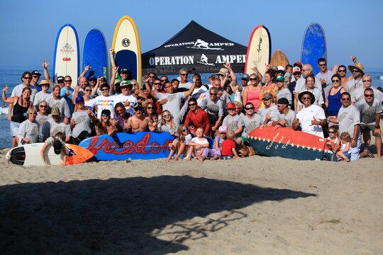 Participants and volunteers gather for a group photo on the final day of a three-day surf camp at Camp Pendleton's San Onofre Beach, Aug. 12. Operation Amped held the sport therapy camp to provide surfing lessons to rehabilitating injured service members and their families.