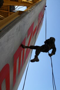 A recruit of Company L, 3rd Recruit Training Battalion, rappels down a 60-foot-wall during recruit training aboard Marine Corps Recruit Depot San Diego Aug. 10. The structure consisted of two rappel walls and a "hell hole," a hole on the top of the platform that drops directly to the ground below.