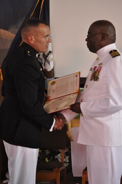 Navy Capt. Ollis J. Mozon, Jr., the Marine Corps Installations-West and Marine Corps Base Camp Pendleton chaplain, recieves a letter of commendation from Brig. Gen. Vincent A Coglianese, commanding general of MCI-West, MCB Camp Pendleton, during his retirement ceremony at the Blinder Memorial Chapel here, Aug. 17. Mozon also recieved letters from President Obama and the mayors of North Carolina and Maryland.