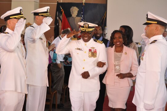 Navy Capt. Ollis J. Mozon, Jr., the Marine Corps Installations-West and Marine Corps Base Camp Pendleton chaplain, salutes as he goes "ashore" with his family for the last time during his retirement ceremony at the Blinder Memorial Chapel here, Aug. 17. Mozon, retired after 30 years of service.
