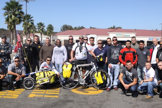 Scot King, a former Marine and president of The Wounded Ride, Inc., a nonprofit organization committed to financially assisting combat wounded veterans and their families, poses with Marines from the Brotherhood of United States Marine Corps Riders during an impromptu photo shoot at the McDonald's here, Aug. 28. King is riding more than 15,000 miles across the country to raise awareness and donations for active duty and veteran service members.