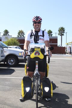 Scot King, a former Marine and president of The Wounded Ride, Inc., a nonprofit organization committed to financially assisting combat wounded veterans and their families, strikes a pose on his bicycle during a rest stop at the McDonald's here, Aug. 28. King's ride will culminate in a ceremony raising the flags of each state he has visited in honor of those who have and do serve in the military.