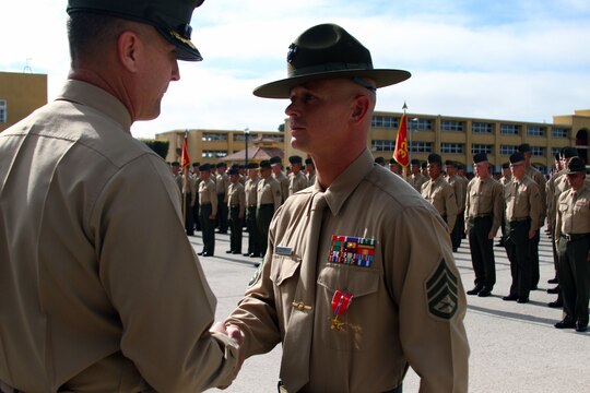 Staff Sgt. Christopher Shranko, drill instructor, Company L, 3rd Recruit Training Battalion, shakes hands with Colonel Michael Lee, commanding officer of Recruit Training Regiment, during his award ceremony aboard Marine Corps Recruit Depot San Diego Nov. 29.  Shranko was awarded a Bronze Star with Valor for his actions while deployed to Afghanistan April through October 2011.  Shranko has deployed to combat five times.