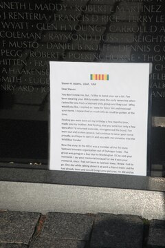 Visitors leave flags, letters and other mementos at the foot of the Vietnam Memorial in Washington D.C. Nov. 10. After so long the mementos are taken and placed in a museum that houses all the things left at the wall.