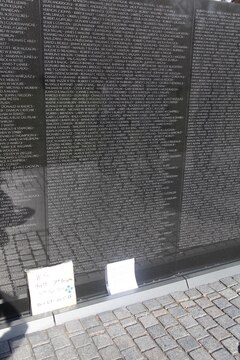 Visitors leave flags, letters and other mementos at the foot of the Vietnam Memorial in Washington D.C. Nov. 10. After so long the mementos are taken and placed in a museum that houses all the things left at the wall.