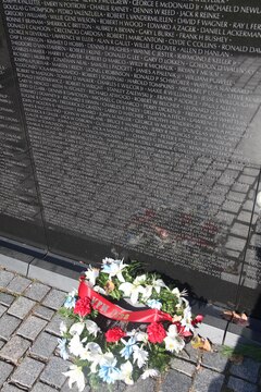 Visitors leave flags, letters and other mementos at the foot of the Vietnam Memorial in Washington D.C. Nov. 10. After so long the mementos are taken and placed in a museum that houses all the things left at the wall.