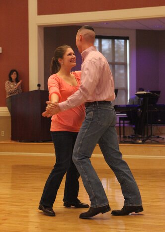 1st Lt. Joseph Lukefahr, the assistant operations officer with 1st Battalion, 10th Marine Regiment, 2nd Marine Division, and his wife Kristen perform a country dance during the Officers Wives’ Club annual luncheon at Marston Pavilion aboard Marine Corps Base Camp Lejeune, Feb. 14. Dancing with Division was theme for the 2nd Marine Divisions OWC.