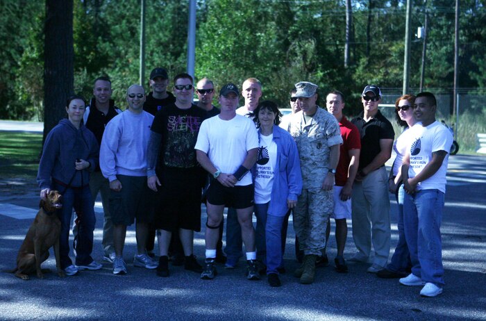 Gunnery Sgt. James J. Dacey, company gunnery sergeant for Support Company, 8th Engineer Support Battalion, 2nd Marine Logistics Group, poses for a photo with Marines from his unit aboard Camp Lejeune, N.C., Oct. 22, 2011, before his 345-mile run to National Naval Medical Center, Bethesda, Md. The North Arlington, N.J., native is conducting the run to raise awareness about our nation’s wounded warriors and for the service members we’ve lost to the war. (U.S. Marine Corps photo by Pfc. Franklin E. Mercado)