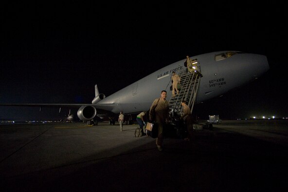 U.S. Air Force Tech. Sgt. Chris Whynott, a KC-10 Extender flight engineer from the 908th Expeditionary Air Refueling Squadron, walks to a crew bus after a flight over Afghanistan Feb. 27, 2012. The 908th EARS provides critical air refueling to aircraft in the area of responsibility, delivering more than one million gallons of fuel to the fight every day. In 2011, the 908th EARS offloaded more than 390 million pounds of fuel to more than 28,000 aircraft, and flew more than 36,700 hours in almost 4,600 missions. The average sortie length for a KC-10 mission in Southwest Asia is about eight hours. (U.S. Air Force photo by Staff Sgt. Greg Biondo) 
