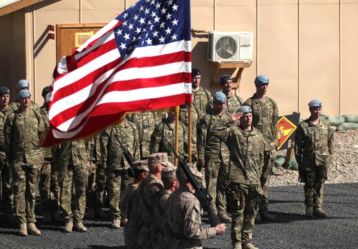 British servicemembers from the Joint Helicopter Force (Afghanistan) salute as the colors are retired during a transfer of authority ceremony at Camp Leatherneck, Afghanistan, Feb. 29. British forces routinely work side by side with their American counterparts in support of operations in Afghanistan.