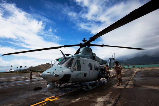 Air crews from Marine Light Attack Helicopter Squadron 169 prepare a UH-1Y “Super Huey” for flight as Capt. Jonathan A. Chunn, CH-53E pilot with Marine Heavy Helicopter Squadron 463, conducts pre-flight checks during cross-cockpit training July 7, as part of Rim of the Pacific 2012. Multiple detachments of aviation and support units will be assigned to HMH 463 (reinforced) during RIMPAC 12 to comprise the aviation combat element of Special Purpose Marine Air-Ground Task Force 3. Approximately 2,200 personnel from nine nations comprise SPMAGTF-3, Combined Force Land Component Command. The CFLCC is conducting amphibious and land-based operations in order to enhance multinational and joint interoperability. (U.S. Marine Corps Photo by Cpl. Isis M. Ramirez/Released)