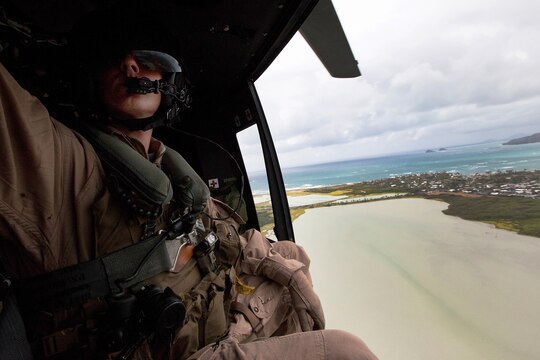 Cpl. Nicholas P. Brazil, helicopter crew chief with Marine Light Attack Helicopter Squadron 169, adjusts radio wires aboard a UH-1Y Super Huey July 7 during cross-cockpit training with pilots of Marine Heavy Helicopter Squadron 463 as part of Rim of the Pacific 2012. Multiple detachments of aviation and support units will be assigned to HMH 463 (reinforced) during RIMPAC 12 to comprise the aviation combat element of Special Purpose Marine Air-Ground Task Force 3. Approximately 2,200 personnel from nine nations comprise SPMAGTF-3, Combined Force Land Component Command. The CFLCC is conducting amphibious and land-based operations in order to enhance multinational and joint interoperability.