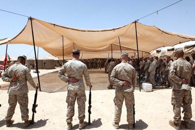 Marines bow their heads in a moment of prayer during a memorial ceremony, July 8, 2012. During the ceremony, Marines paid tribute to Pfc. Steven P. Stevens II, Lance Cpl. Niall W. Coti-Sears, Lance Cpl. Hunter D. Hogan and Lance Cpl. Eugene C. Mills III. Stevens and Mills were killed in action June 22 while participating in Operation Jaws in the Sangin Valley District, Afghanistan. Hogan and Coti-Sears were killed in action the following day during the same operation. Stevens was a combat engineer with 1st Combat Engineer Battalion supporting Weapons Company. Coti-Sears was a rifleman with Weapons Co. Hogan and Mills were riflemen with Bravo Co. attached to Weapons Co.