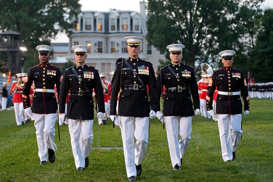 The parade staff marches during a retirement ceremony at Marine Barracks Washington July 23.