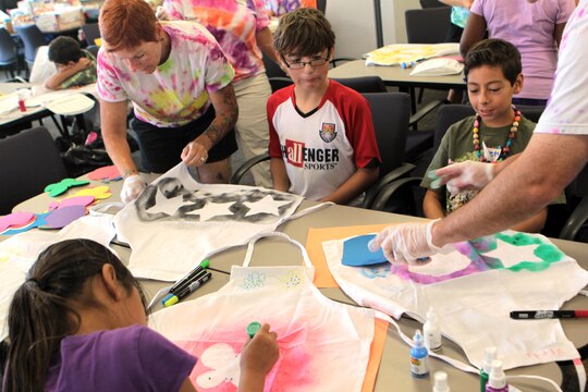 The children at Camp Camo design and create their own aprons in the classroom at the Paige Fieldhouse, July 31. A few other activities the children participate in are a water balloon toss, growing a plant, making a scrapbook and making their own healthy snacks and lunches.