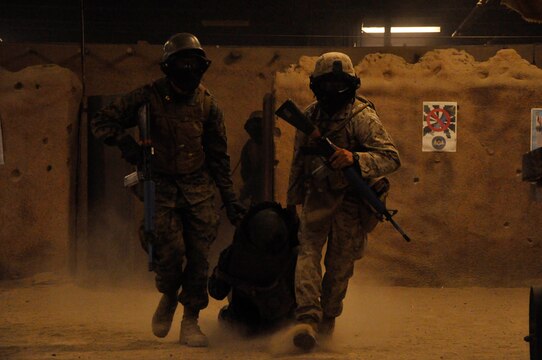 Naval Reserve Officer Training Corp’s (NROTC) Midshipmen, and a Marine Squad leader (volunteer) escort a casualty to safety in the streets of a combat town simulating an Afghanistan marketplace, during urban warfare training at the Annual Career Orientation for Midshipmen Summer Training Program, on Camp Pendleton, June 14. Midshipmen were introduced to the Marine Corps, military operations in urbanized terrain, counterinsurgency operations at the Infantry Immersion Trainer, the importance of small unit leadership and interactions with Marine officers and non-commissioned officers. They accomplished this by having squad and fire-team level urban scenarios, which integrated role-playing and culture training.