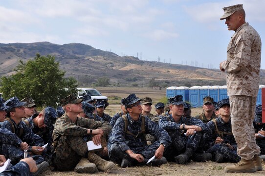 Brig. Gen. Vincent A. Coglianese, commanding general of Marine Corps Installations-West, Marine Corps Base Camp Pendleton, speaks to the Naval Reserve Officer Training Corps' (NROTC) Midshipmen about what its like to be a junior commissioned officer, during urban warfare training at the Annual Career Orientation for Midshipmen Summer Training Program, on Camp Pendleton, June 14. Midshipmen were introduced to the Marine Corps, military operations in urbanized terrain, counterinsurgency operations at the Infantry Immersion Trainer, the importance of small unit leadership and interactions with Marine officers and non-commissioned officers. They accomplished this by having squad and fire-team level urban scenarios, which integrated role-playing and culture training.