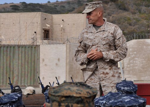 Brig. Gen. Vincent A. Coglianese, commanding general of Marine Corps Installations-West, Marine Corps Base Camp Pendleton, speaks to the Naval Reserve Officer Training Corp’s (NROTC) Midshipmen about what its like to be a junior commissioned officer, during urban warfare training at the Annual Career Orientation for Midshipmen Summer Training Program, on Camp Pendleton, June 14. Midshipmen were introduced to the Marine Corps, military operations in urbanized terrain, counterinsurgency operations at the Infantry Immersion Trainer, the importance of small unit leadership and interactions with Marine officers and non-commissioned officers. They accomplished this by having squad and fire-team level urban scenarios, which integrated role-playing and culture training.