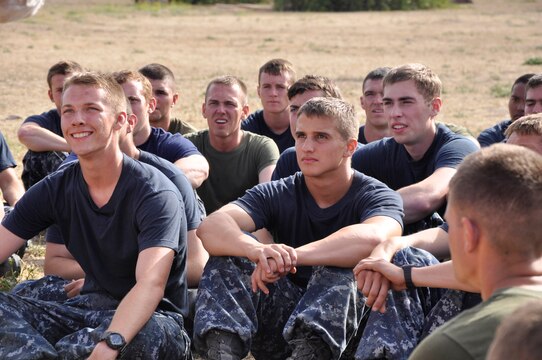 Naval Reserve Officer Training Corp’s (NROTC) Midshipmen, listen to the words of their commander after participating in urban warfare training, during the Annual Career Orientation for Midshipmen Summer Training Program, at Camp Pendleton, June 14. Midshipmen were introduced to the Marine Corps, military operations in urbanized terrain, counterinsurgency operations at the Infantry Immersion Trainer, the importance of small unit leadership and interactions with Marine officers and non-commissioned officers. They accomplished this by having squad and fire-team level urban scenarios, which integrated role-playing and culture training.