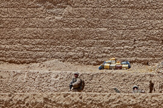 Sgt. Michael Smith, an Explosive Ordnance Disposal technician and assistant team leader, 1st EOD Company, 1st Marine Logistics Group (Forward), provides security prior to conducting a controlled detonation of more than 25 improvised explosive devices June 15. The IEDs were removed from the battlefield in the Sangin District in Helmand Province, Afghanistan.