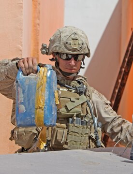 Staff Sgt. Robert Conlon, an Explosive Ordnance Disposal Technician and team leader with 1st EOD Company, 1st Marine Logistics Group (Forward), gathers improvised explosive devices that were removed from the Sangin District in Helmand Province, Afghanistan, June 15. After removing more than 25 IEDs, Conlon’s team conducted a controlled detonation to eliminate the explosive threats.
