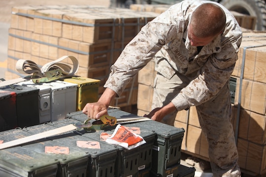 Lance Cpl. Matthew Tiffin, a motor transport operator with General Support Motor Transport, 1st Maintenance Battalion (-) (Reinforced), 1st Marine Logistics Group (Forward), tightens down a load of ammunition during a mass movement at Camp Leatherneck, Afghanistan, June 18. During the move, Marines transferred more than 6.6 million rounds from the Field Ammunition Supply Point to the new Munitions Storage Area.