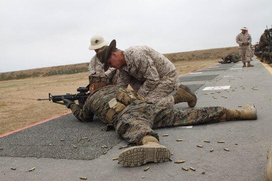 Primary Marksmanship Instructors assit Company K recruits during firing week June 15 aboard Edson Range, Weapons and Field Training Battalion, Marine Corps Base Camp Pendleton, Calif. Many recruits have not shoot and M16-A4 service rifle before so the PMI's make sure the recruits understand the fundamentals of Marine Corps Marksmanship. Co. K also had the privilege of shooting with Rifle Combat Optics, a new requirment for Marines in the fleet when qualifying.