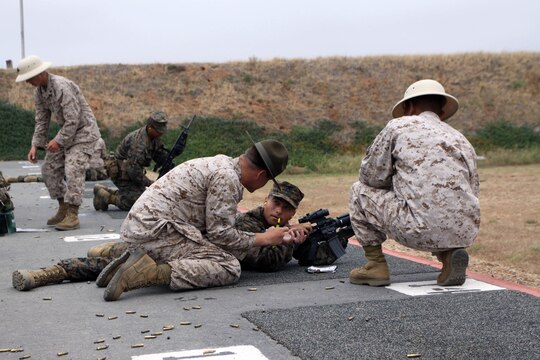 Primary Marksmanship Instructors assit Company K recruits during firing week June 15 aboard Edson Range, Weapons and Field Training Battalion, Marine Corps Base Camp Pendleton, Calif. Many recruits have not shoot and M16-A4 service rifle before so the PMI's make sure the recruits understand the fundamentals of Marine Corps Marksmanship. Co. K also had the privilege of shooting with Rifle Combat Optics, a new requirment for Marines in the fleet when qualifying.