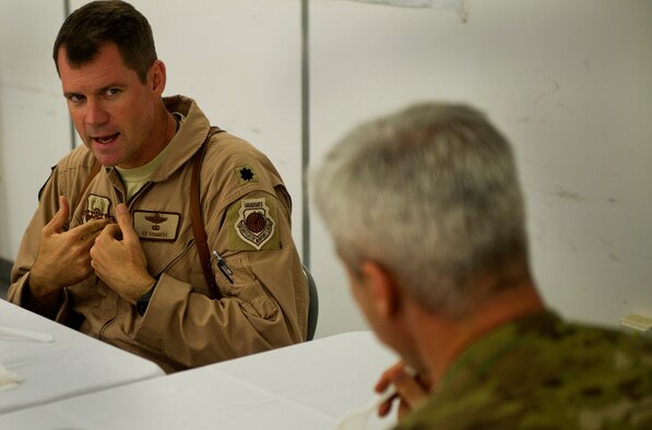 Lt. Col. Ed Sommers, 651st Air Expeditionary Group deputy commander, explains issues he's facing to Chief Master Sgt. Robert Sealey, U.S. Air Forces Central command chief at Camp Bastion, Afghanistan, March 16, 2012. During this dinner meeting, Sommers explained how his group often faces challenges being located away from an U.S. air base. The very next day, Sealey was able to get the base commandant to agree for an Air Force representative to be on the Camp's board. (U.S. Air Force photo by Staff Sgt. David Salanitri) 

