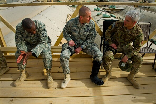 From left, Chief Master Sgt. Al Herrring, 9th Air and Space Expeditionary Task Force - Afghanistan command chief, looks on as Chief Master Sgt. Thomas Vallely, 451st Air Expeditionary Wing command chief makes a remark to Chief Master Sgt. Robert Sealey, U.S. Air Forces Central command chief, March 15, 2012 at Kandakar Airfield, Afghanistan. Over two days, Sealey visited Airmen of the 451st AEW, briefing them on current AFCENT operations and answering questions. (U.S. Air Force photo by Staff Sgt. David Salanitri) 