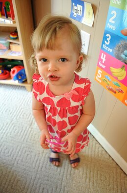 Charlotte Richards, 1, takes a break from learning numbers at the Phaneuf residence in Goldsboro, N.C., May 7, 2012. Family child care is not solely a babysitting service, the providers assist in the development of the military and DoD civilian children they care for. Charlotte is the daughter of Maj. Chad Richards, 333rd Fighter Squadron F-15E Strike Eagle upgrade instructor pilot, and hails from Goldsboro, N.C. (U.S. Air Force photo/Airman 1st Class Aubrey Robinson/Released)
