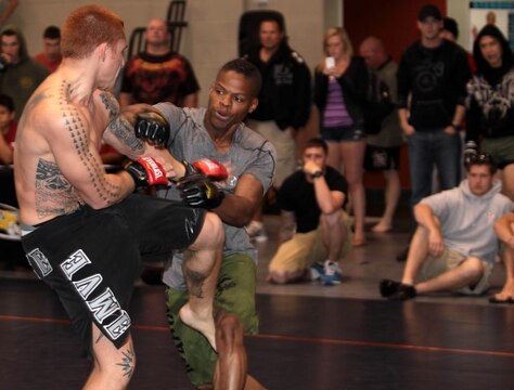 (Left) Steven Pina, from the Air Force, blocks incoming punches and counters; winning him the match and second place in the 170 pound weight division of the 2012 US Armed Services Pankration Championship at Camp Horno, May 12.