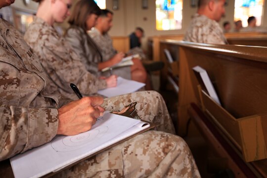 Service members and Deparment of Defense personnel draw a bullseye during an activity to understand networking at the Marketing Yourself presentation at the Marine Memorial Chapel on Camp Pendleton, May 15. The activity was a way to find reliable references by listing a few people and grouping them by how well they are known.