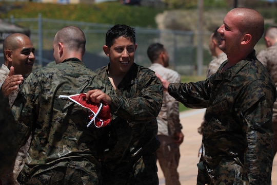 The Marine Corps Base, Camp Pendleton team takes advice from another player during half-time of a combat water polo game, May 16, at Camp Pendleton’s 13 Area Pool. Combat water polo was modified from the traditional sport of water polo to provide Marines and sailors the increased safety of a shallow playing field while maintaining difficulty by adding combat boots and utilities.