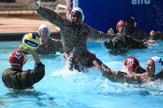 Thaddaeus I. Haney explodes upward and out of the water in an attempt to block an opponent’s pass during a combat water polo game, May 16 at Camp Pendleton’s 13 Area Pool. Combat water polo was modified from the traditional sport of water polo to provide Marines and sailors the increased safety of a shallow playing field while maintaining difficulty by adding combat boots and utilities.