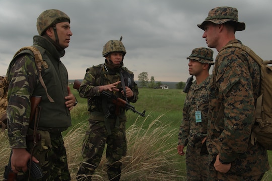 Marines with Regimental Combat Team 5 and members of the Afghan National Army's military police question local Afghans in southwestern Afghanistan May 17. Marine Heavy Helicopter Squadron 466 supported vehicle interdiction operations, searching for potential drug traffickers in the area.