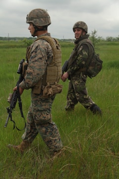 Marines with Regimental Combat Team 5 and members of the Afghan National Army's military police search a local Afghan's vehicle in southwestern Afghanistan May 17. Marine Heavy Helicopter Squadron 466 supported vehicle interdiction operations, searching for potential drug traffickers in the area.