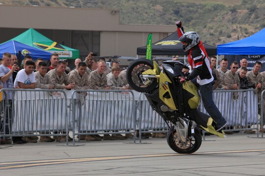 Marines from 1st Marine Division, Marine Air Group 39 and Marine Corps Air Station watch as one of the freestyle demo riders pumps up the crowd at Semper Ride's Fun Day at the Runway on Marine Corps Air Station Camp Pendleton, May 18.