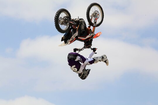 One of the freestyle demo riders performs a mid-air back flip with flair while performing at Semper Ride's Fun Day on the Runway at Marine Corps Air Station Camp Pendleton, May 18.