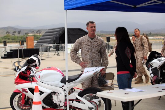 Col. Mike Lawrence, commanding officer of Marine Corps Air Station Camp Pendleton, speaks with a Marine about her unique, custom motorcycle during Semper Ride's Fun Day on the Runway at the Marine Corps Air Station Camp Pendleton, May 18.
