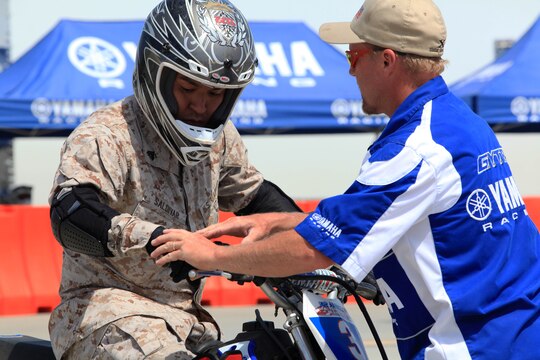 An instructor explains the role of the right hand while riding a motorcycle at Semper Ride's Fun Day on the Runway at Marine Corps Air Station Camp Pendleton, May 18. Fun Day on the Runway was coordinated for the Marines of 1st Marine Division, Marine Air Ground 39 and MCASCP.