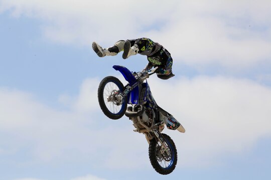 A freestyle demo rider exibits his skills and flexiblity, mid-air at Semper Ride's Fun Day on the Runway at the Marine Corps Air Station Camp Pendleton, May 18. Fun Day on the Runway was coordinated to promote safety in 1st Marine Division, Marine Air Group 39 and MCASCP Marines.