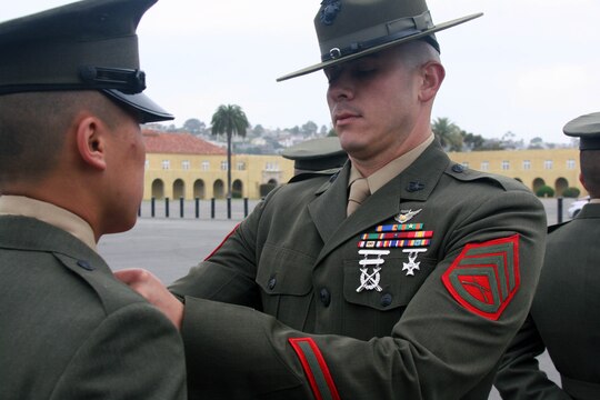Staff Sgt. Zachary Curran, senior drill instructor, Platoon 2113, Company E, 2nd Recruit Training Battalion, inspects his recruits for the Company Commanders Inspection May 19 aboard Marine Corps Recruit Depot. Curran is on his last cycle on the drill field and will be putting in an officer package in the near future.