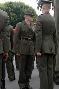 Staff Sgt. Zachary Curran, senior drill instructor, Platoon 2113, Company E, 2nd Recruit Training Battalion, inspects his recruits for the Company Commanders Inspection May 19 aboard Marine Corps Recruit Depot. Curran has spent the last three years molding thousands of individuals who step on the yellow footprints into Marines. While doing that he has also managed to earn a  bachelors degree to help advance his future.