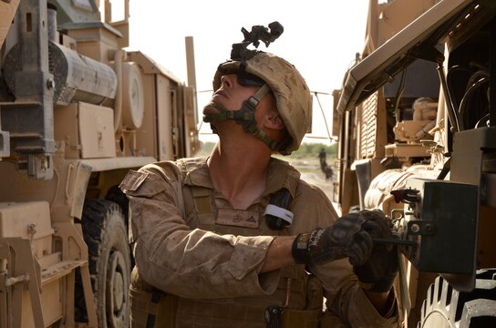 Lance Cpl. Adam R. Tornatore, wrecker operator, Support Company, Combat Logistics Battalion 4, 1st Marine Logistics Group (Forward), operates a crane on a MKR15 Logistics Vehicle System Replacement while adjusting a pallet of water that shifted during a combat logistics patrol in Helmand Province, May 28. The CLB-4 patrol supported Operation Branding Iron.